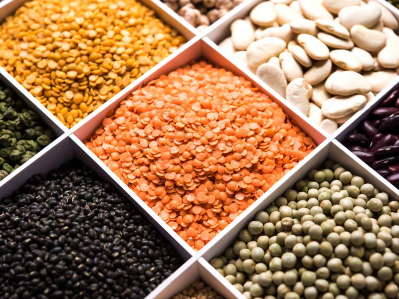 Indian Beans,Pulses,Lentils,Rice and Wheat grain in a white wooden box with cells, selective focus.